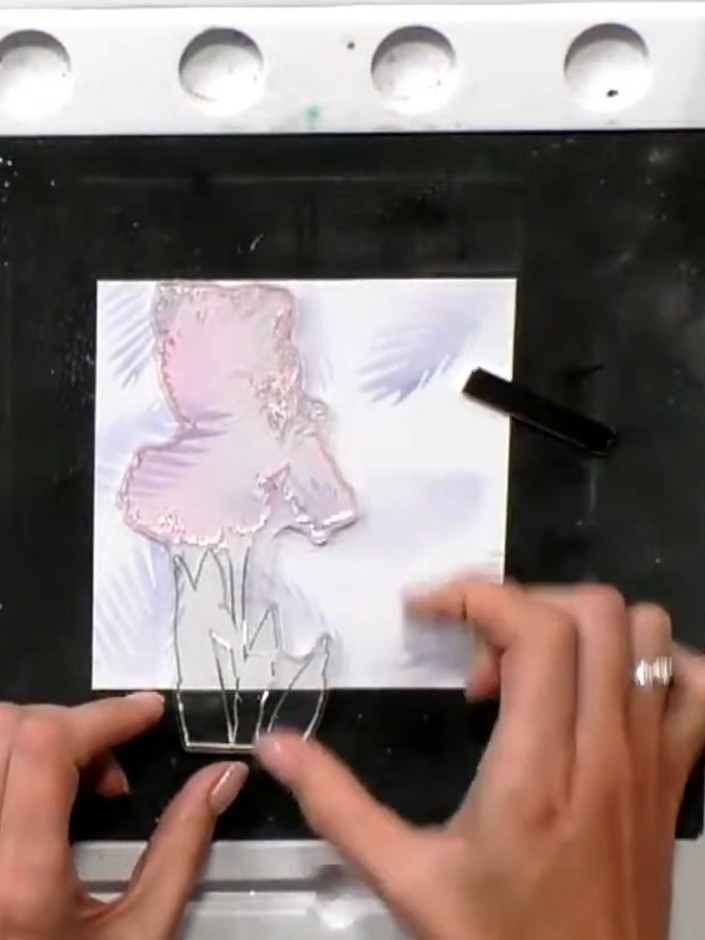 Step 6: Position the iris outline stamp over the stencilled background and stamp it using black ink. Ensure the stamp 