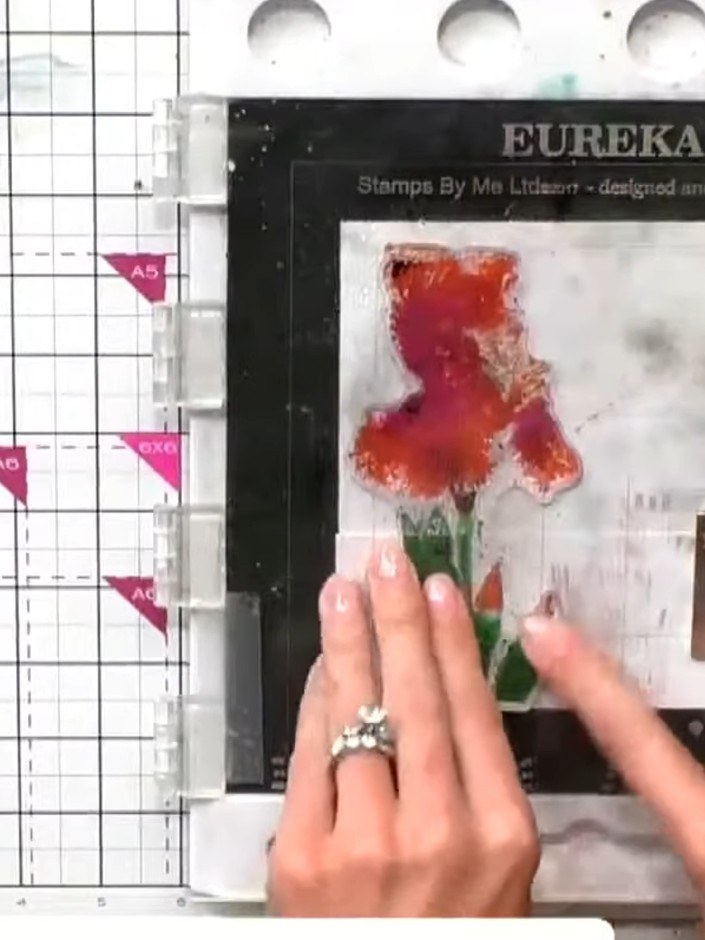 Step 7: Loosely align and stamp the second layer of the iris over the first stamped image, allowing the colours to ove