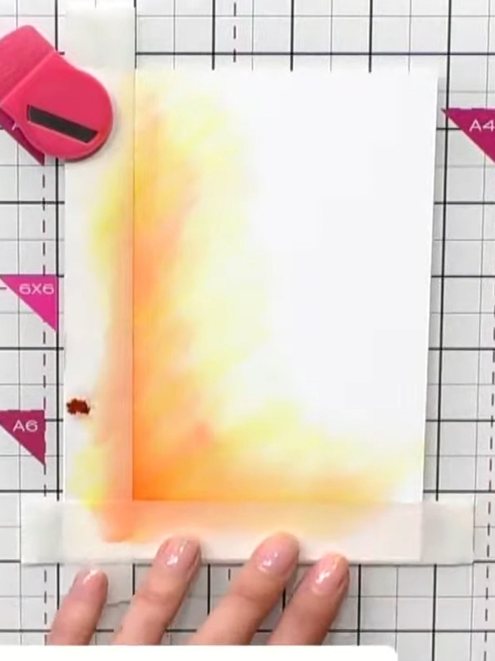 Step 6: Spray the inked stamp with water to activate the watercolour effect. The water will blend the yellow and orang