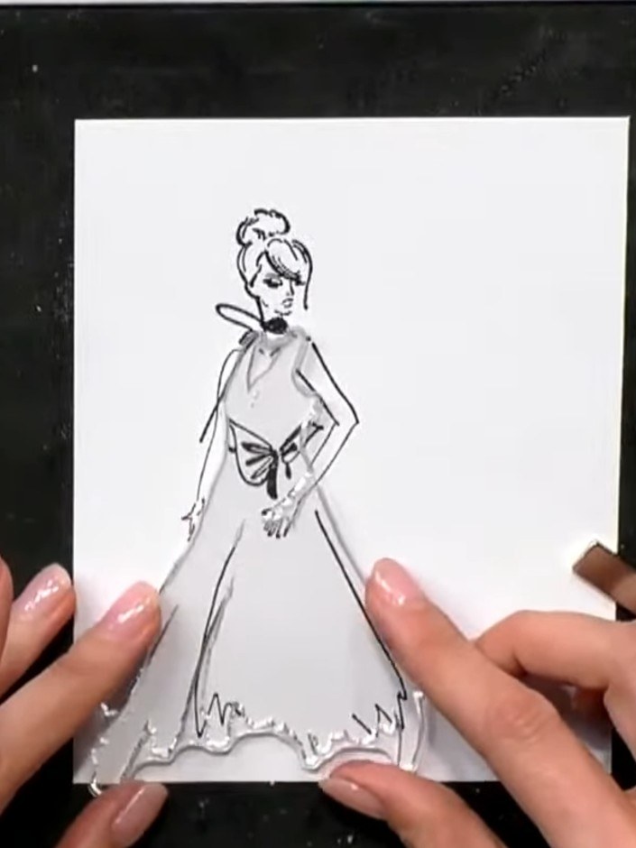 Step 1: Ink the solid portion of the gown stamp outline with black ink using your stamping platform. The stamp shows a