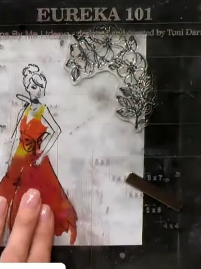 Step 12: Stamp your chosen sentiment (such as 'Happy Birthday') through the gown design using black ink. Position the s