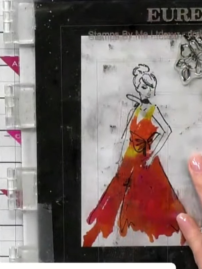 Step 13: Mount the completed laminated fashion figure onto white cardstock, layering it to create depth and dimension. 