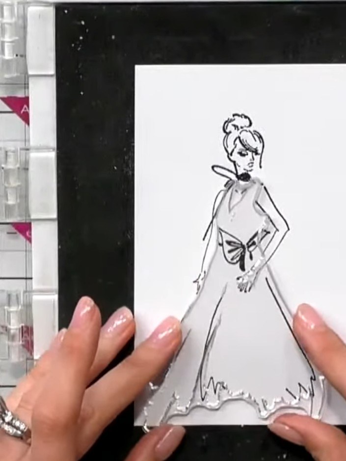 Step 3: Ink the solid portion of the gown stamp with orange ink. Stamp the image onto white cardstock to create a sket