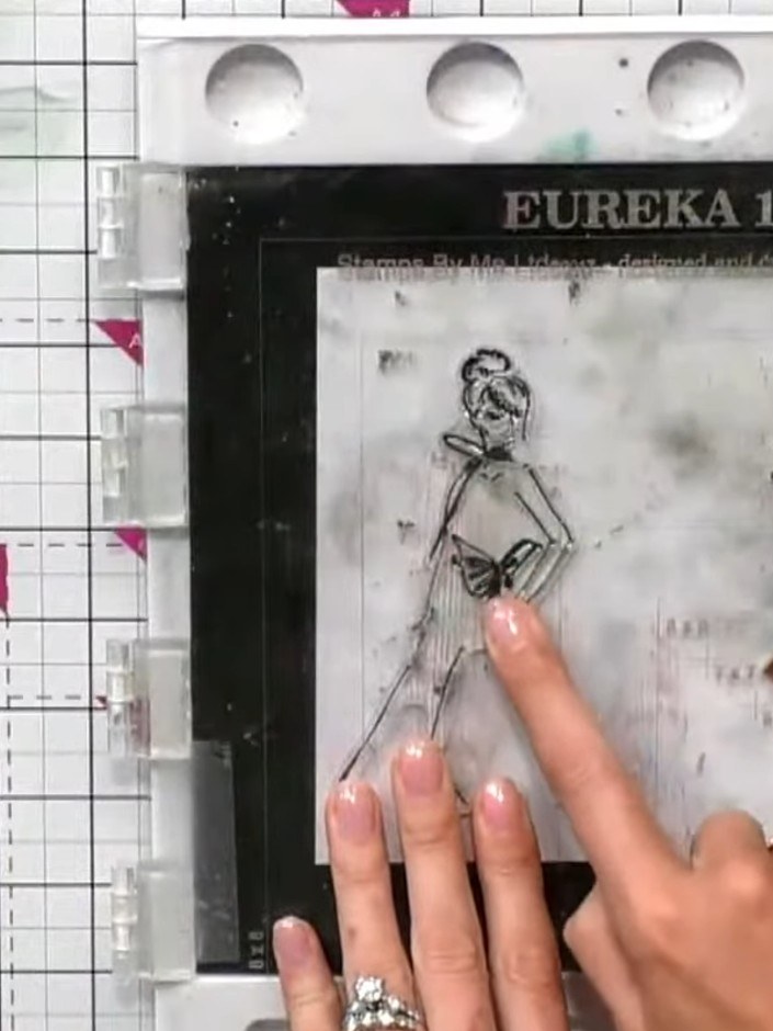 Step 5: Lightly spray the stamped gown image with water to activate the watercolour effect on the ink. Use a fine mist