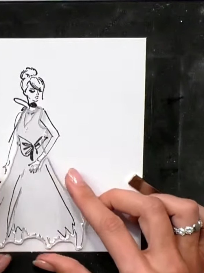 Step 8: Ink the outline stamp of the gown in black ink and carefully layer it over the previously coloured gown image,
