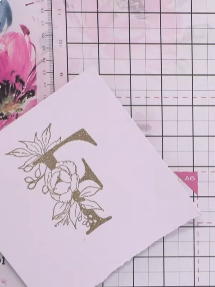 Step 5: Heat set the embossed gold F using a heat gun, holding it at a safe distance from the card until the embossing