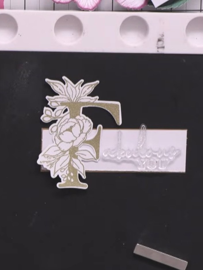 Step 8: Stamp the word 'Fabulous' in gold embossing powder at the top of the white craft border strip, positioning the