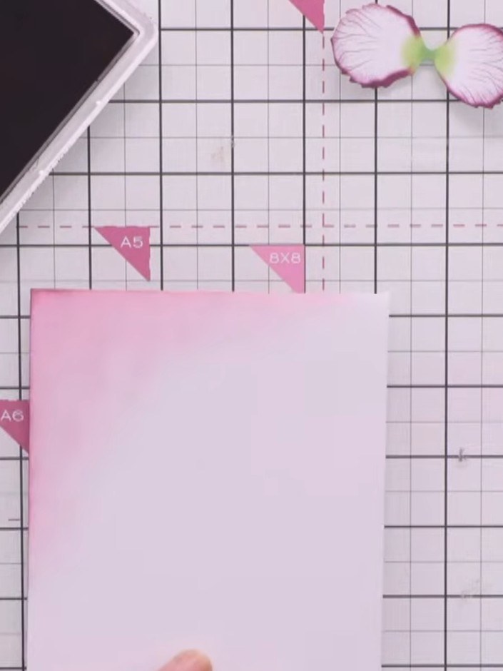 Step 9: Adhere the pink craft border panel to the white card base, ensuring a thin white border is visible around the 