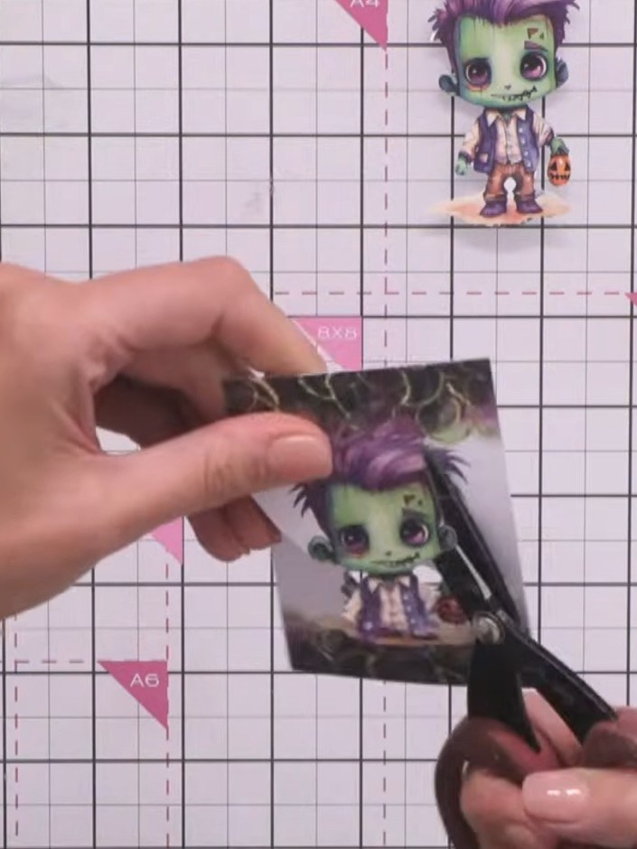 Step 13: Apply foam pads to the back of the cut-out decoupage character piece. Adhere the decoupage layer on top of the