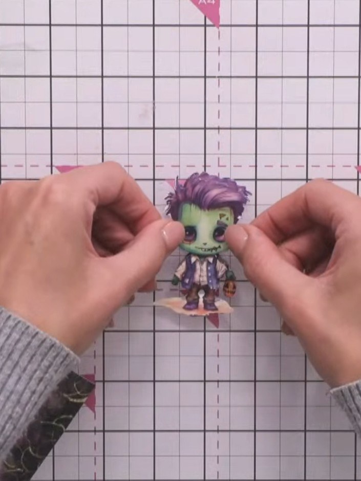 Step 14: Use a black ink pad to edge around the character topper to make it pop and add definition.