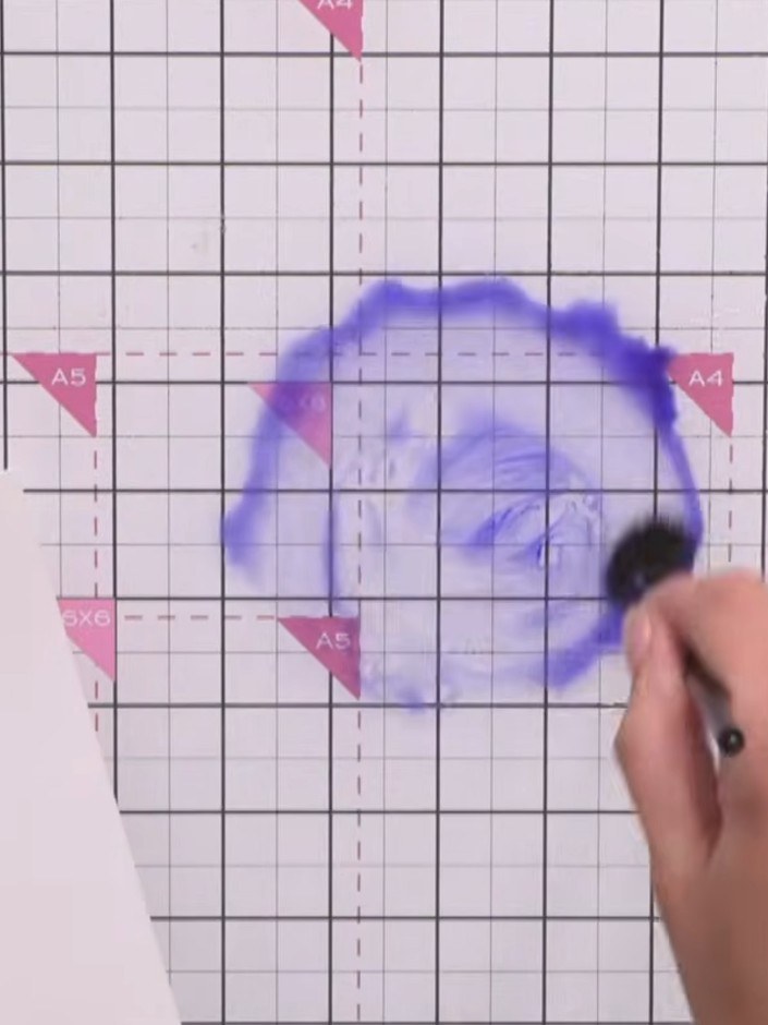 Step 3: Create a large puddle of water in the centre of your glass mat using a water brush or paintbrush.