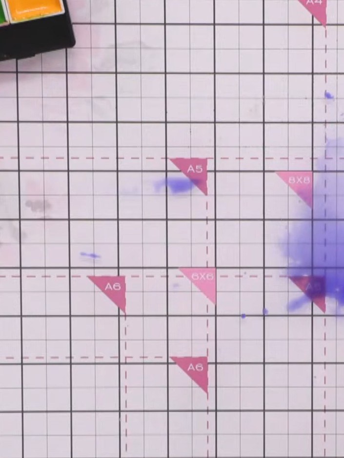 Step 7: Create a second puddle of water on your card. Add purple ink to the puddle and use scrunched tissue paper to d