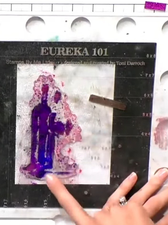 Step 4: Press the stamp firmly onto the white cardstock and hold it down to transfer the blended watercolour effect. T