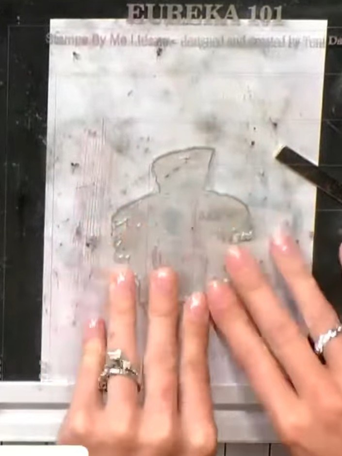 Step 6: Heat emboss the stamped outline using black embossing powder. Apply the powder to the wet ink, tap off the exc
