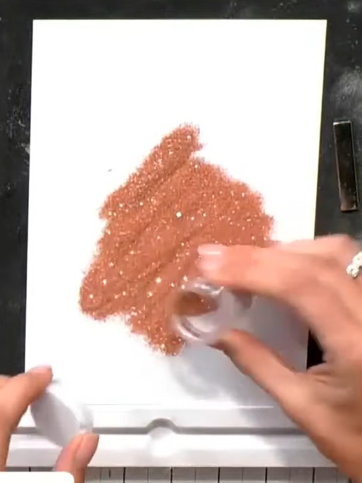 Step 7: Mount the finished embossed and glittered dress design onto your chosen cardstock base to complete the card.