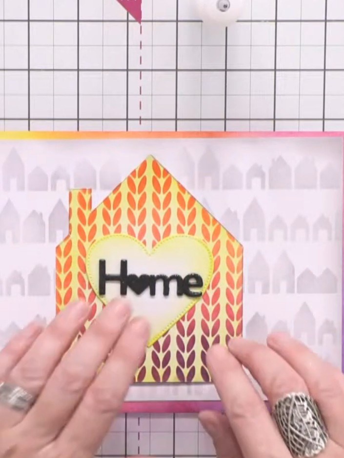 Step 12: Adhere a small die-cut house silhouette in black card inside the aperture of the card as a finishing touch.