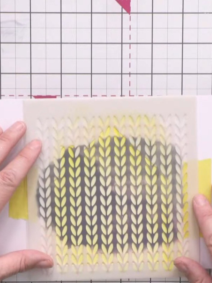 Step 3: Place the knitted pattern stencil over the house aperture. Using magenta ink, work from the bottom of the sten