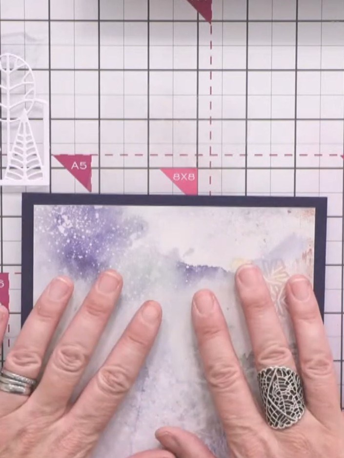 Step 1: Select two complementary papers from the White Magic pad—one featuring blue snowflakes and music notation, and