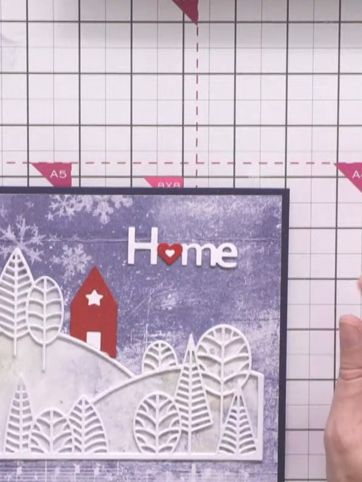 Step 11: Die-cut the word 'Home' from red cardstock. Carefully cut out the integral heart from the 'o' and layer it bac