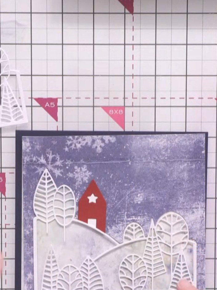 Step 6: Back the small red house die-cut with white card so the window and door apertures remain solid. Trim around th