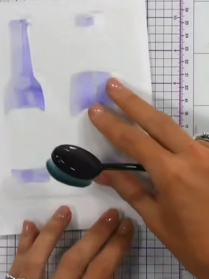Step 1: Position your beer bottle stencil on white card stock. Using a blending tool or sponge, apply purple ink throu