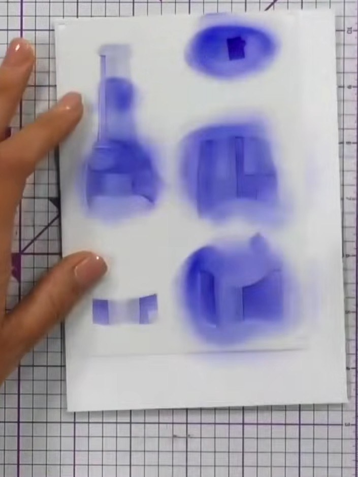Step 3: Continue layering additional stencils in sequence over the bottle area, applying purple ink through each layer
