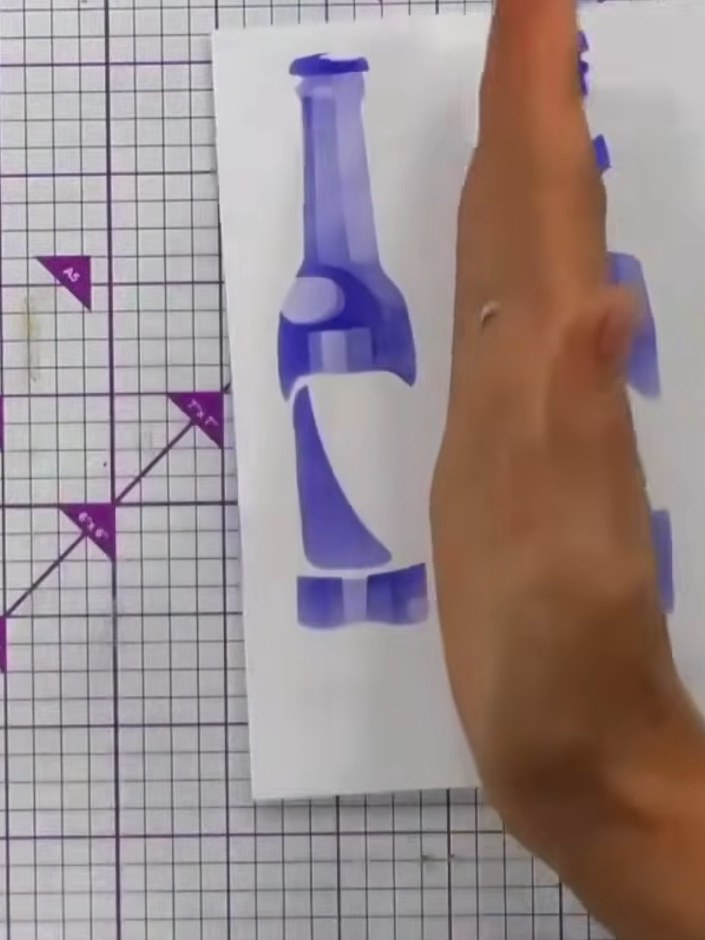 Step 4: Ink up your beer bottle stamp with black dye-based ink and stamp it onto the stencilled background, positionin