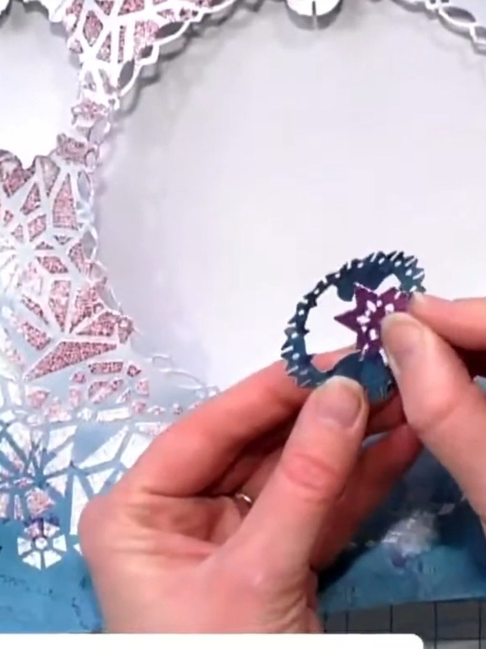 Step 5: Place a small die-cut 3D tree embellishment in the centre of the aperture as a focal point. Position it carefu