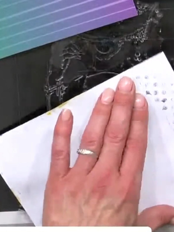 Step 9: Use a heat tool to dry the watercoloured background completely, moving it over the entire surface until the pa