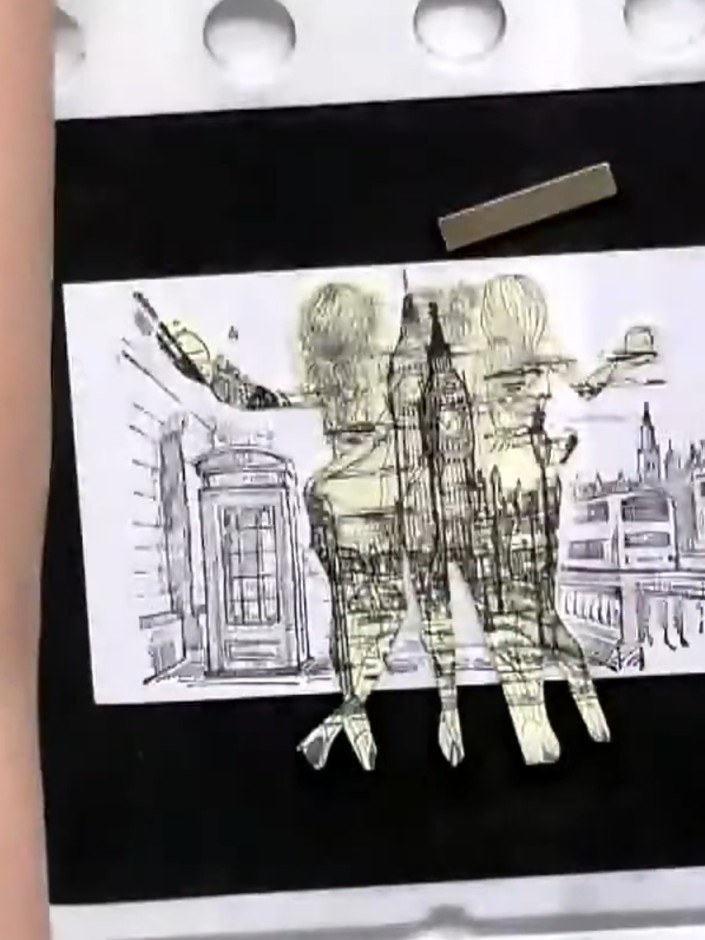 Step 5: Carefully peel away the masking sheet from the stamped image to reveal the layered London scene composition wi