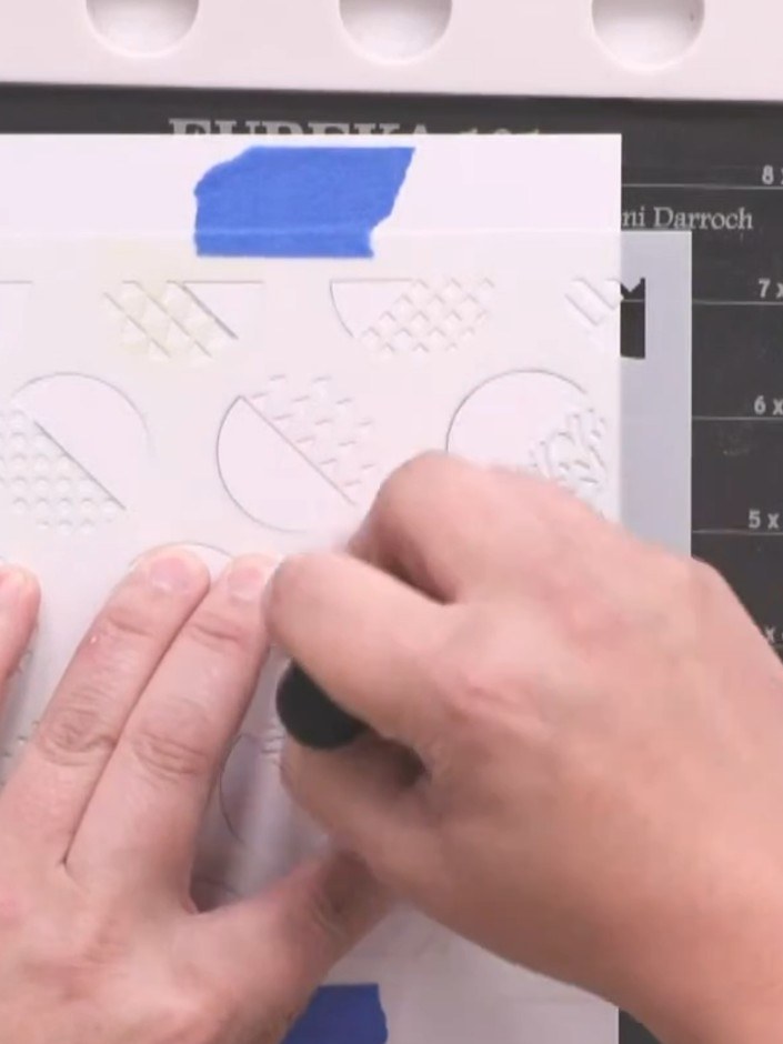 Step 2: Select your distress oxide colours and use a brush to paint individual circles within the stencil. Choose one 