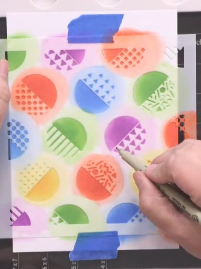 Step 5: Use a black 0.8 liner pen to trace around the semicircle outlines on your stencilled design. Work carefully to