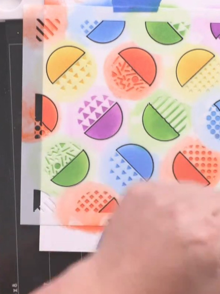 Step 7: Carefully lift and remove the Retro Dots stencil from the card to reveal the finished coloured background with