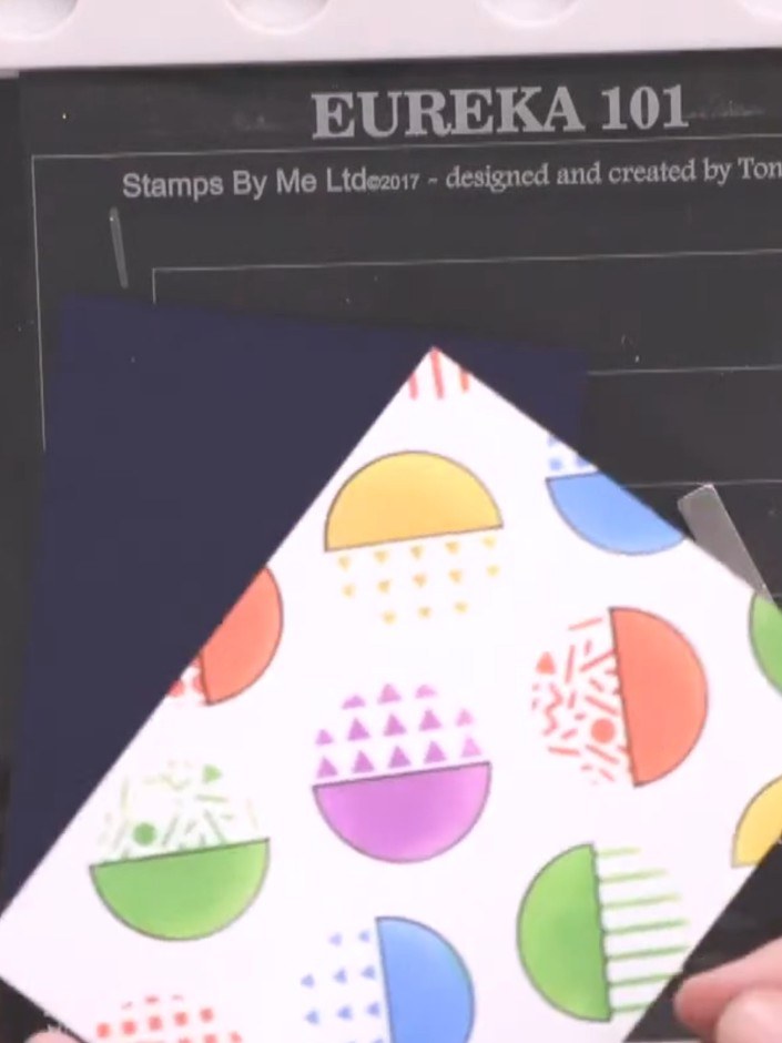 Step 2: Stamp the retro handheld game image around the edges of your card base using black ink to create a decorative 