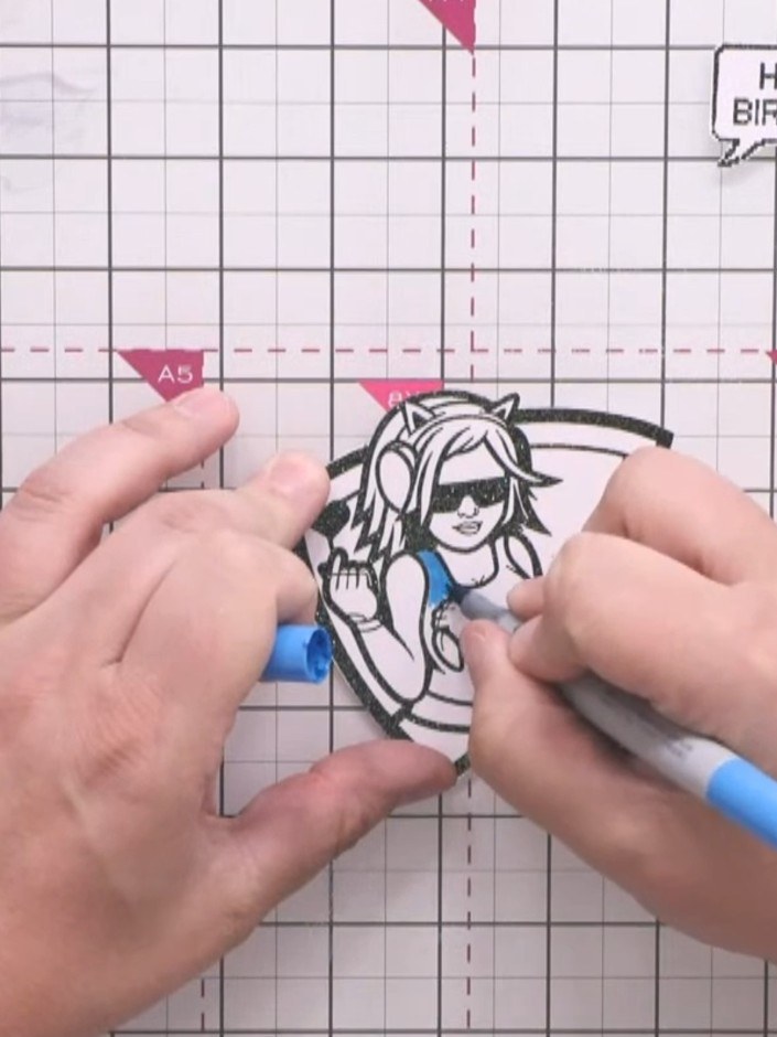 Step 8: Use a pale peach marker to add skin tone warmth to the character's face and arms. Colour gently to avoid the i