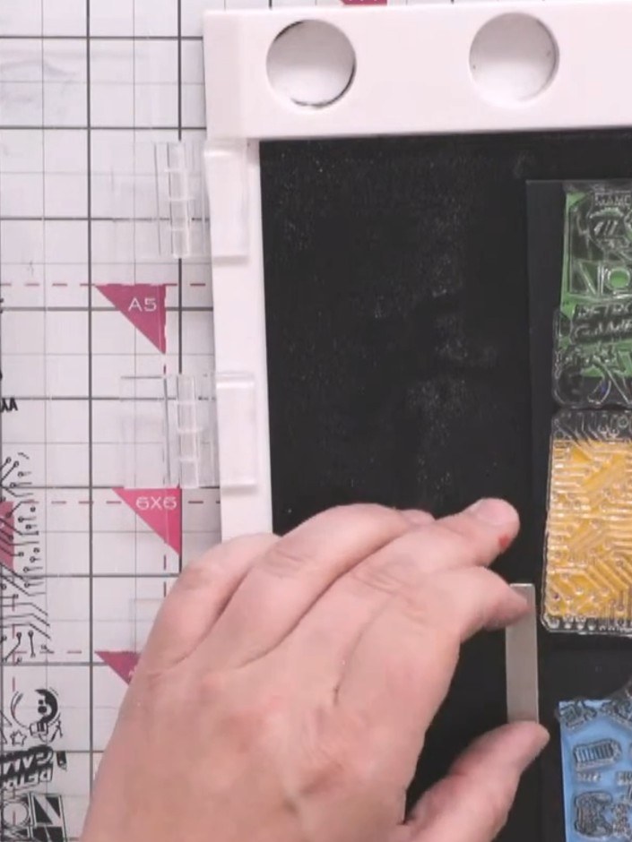 Step 3: Arrange your three stamped strips in your chosen order - green gaming text at the top, orange circuit board pa