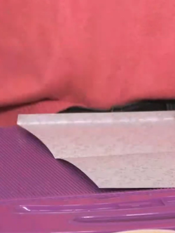 Step 4: Cut from the folded edge up to each score line using scissors, stopping at the line to avoid cutting through.