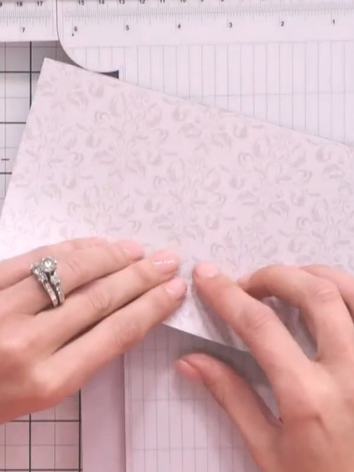 Step 3: Score additional lines approximately 1 inch (2.5 cm) from the top edge of the paper to mark where the internal