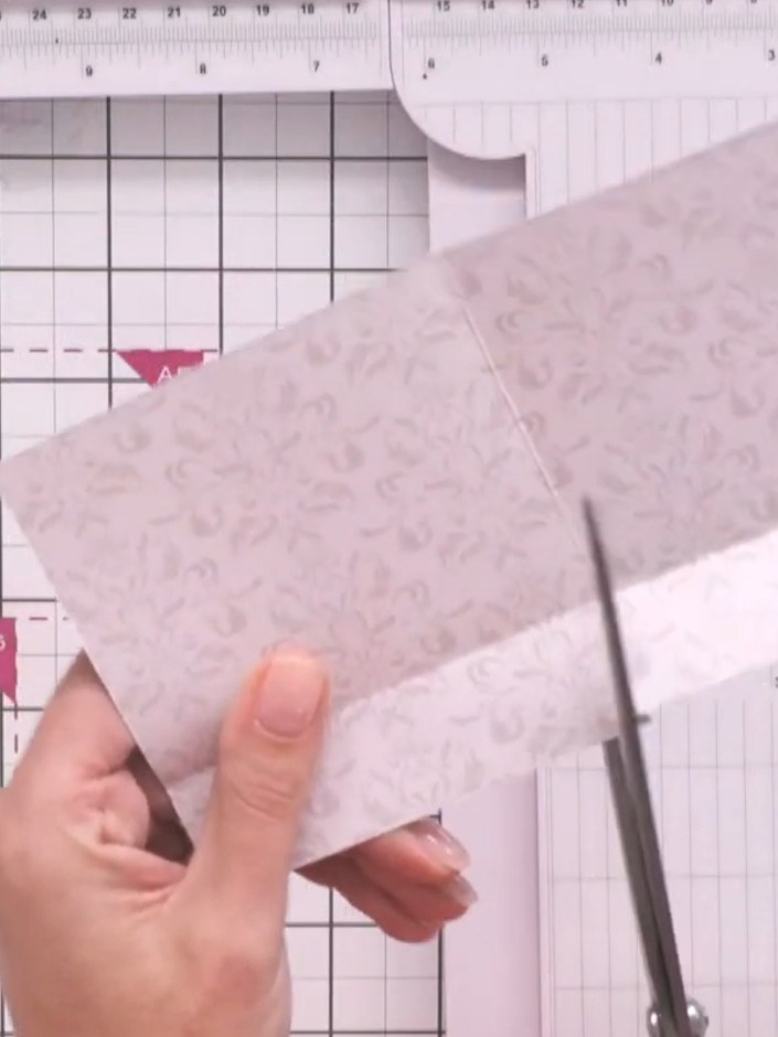 Step 4: Cut from the top edge of the folded paper down to the centre fold line using scissors to create pocket flaps.