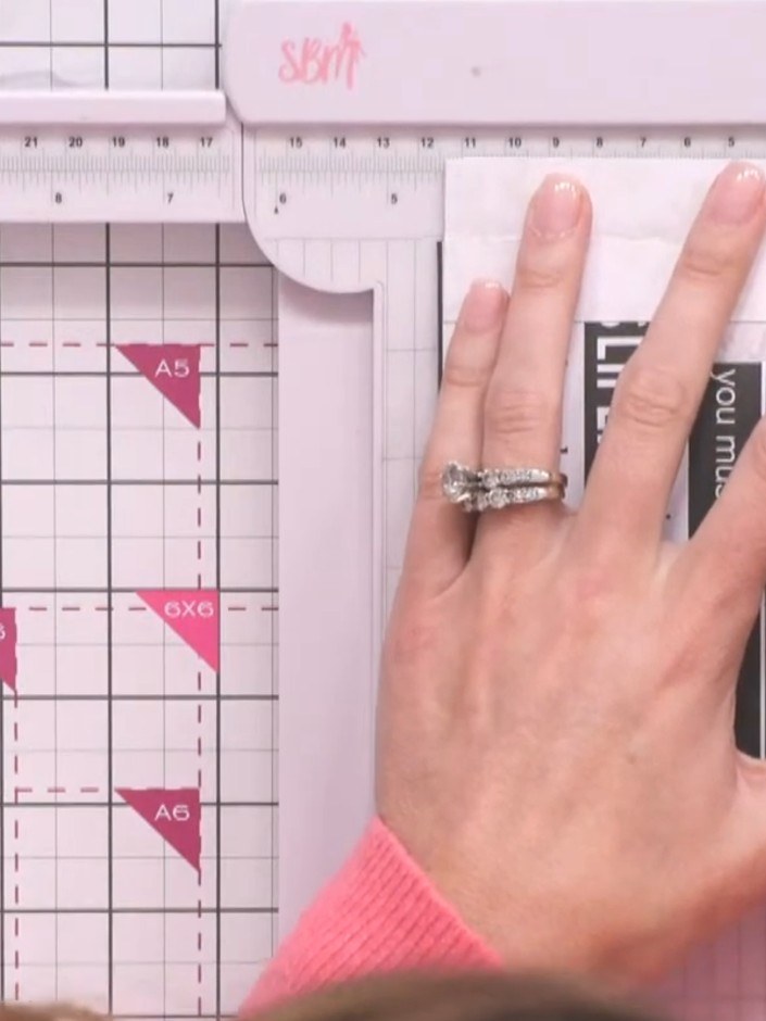 Step 3: Score the pink card at 4.5 inches on each side using a ruler and scoring tool to mark where the tunnel opening