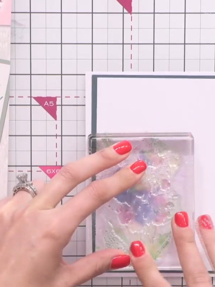 Step 2: Apply purple ink loosely to the centre of the flower design on the stamp. Don't worry about being precise with