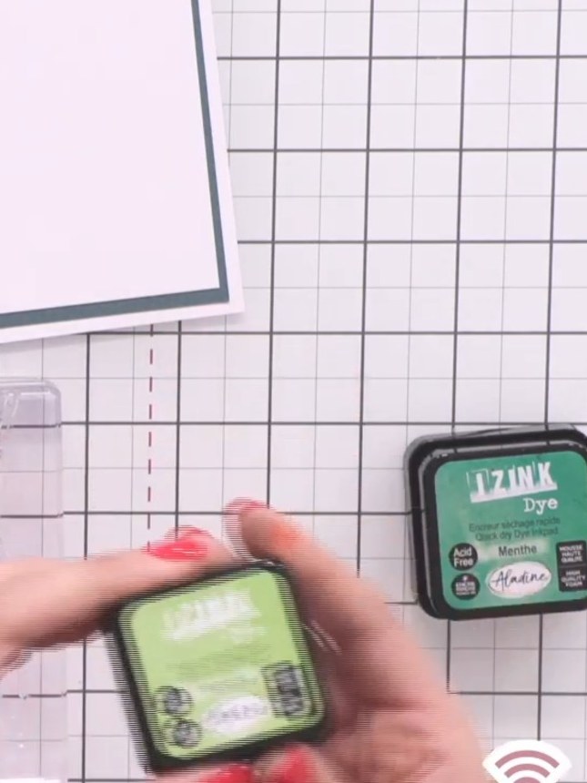 Step 4: Apply light green ink to the leaf elements on the stamp using an ink pad in a mint or lime green shade.