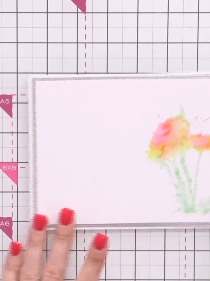 Step 6: Press the wet, coloured stamp firmly onto your white cardstock to transfer the watercolour blended flower desi