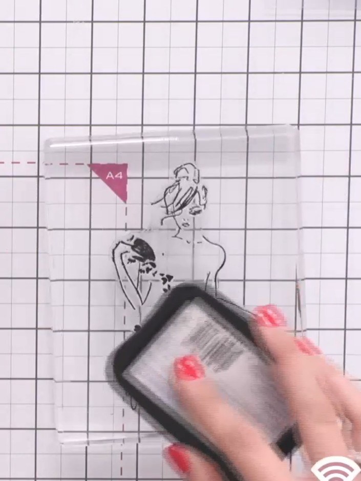 Step 3: Stamp the lady figure in the centre of your white cardstock using the black ink pad. Ensure you capture all th