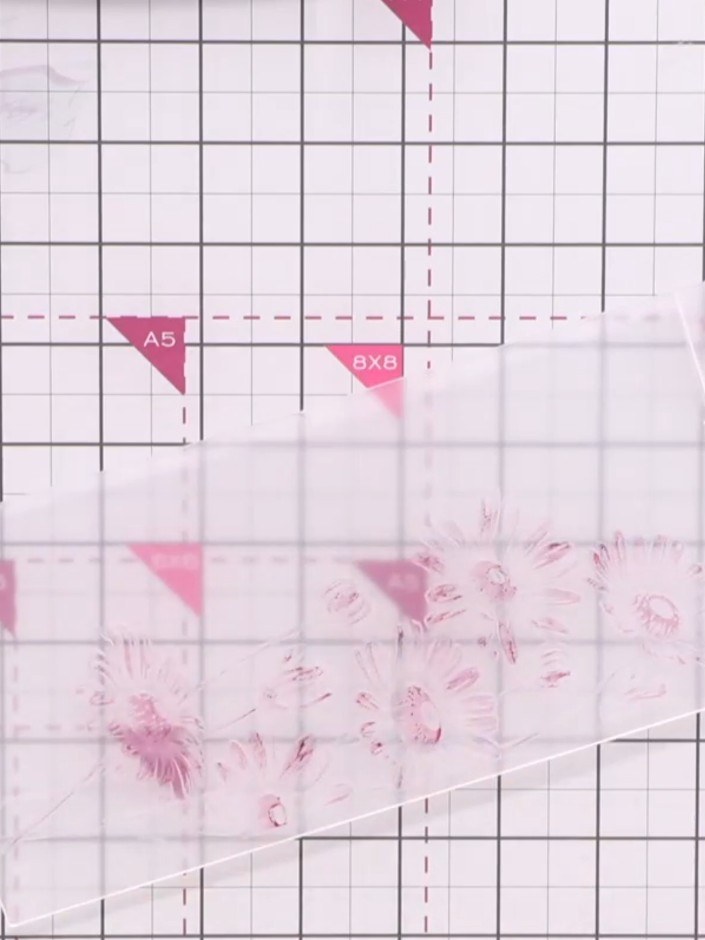 Step 3: Place the inked cardstock over the daisy design inside the embossing folder, ensuring it is positioned correct