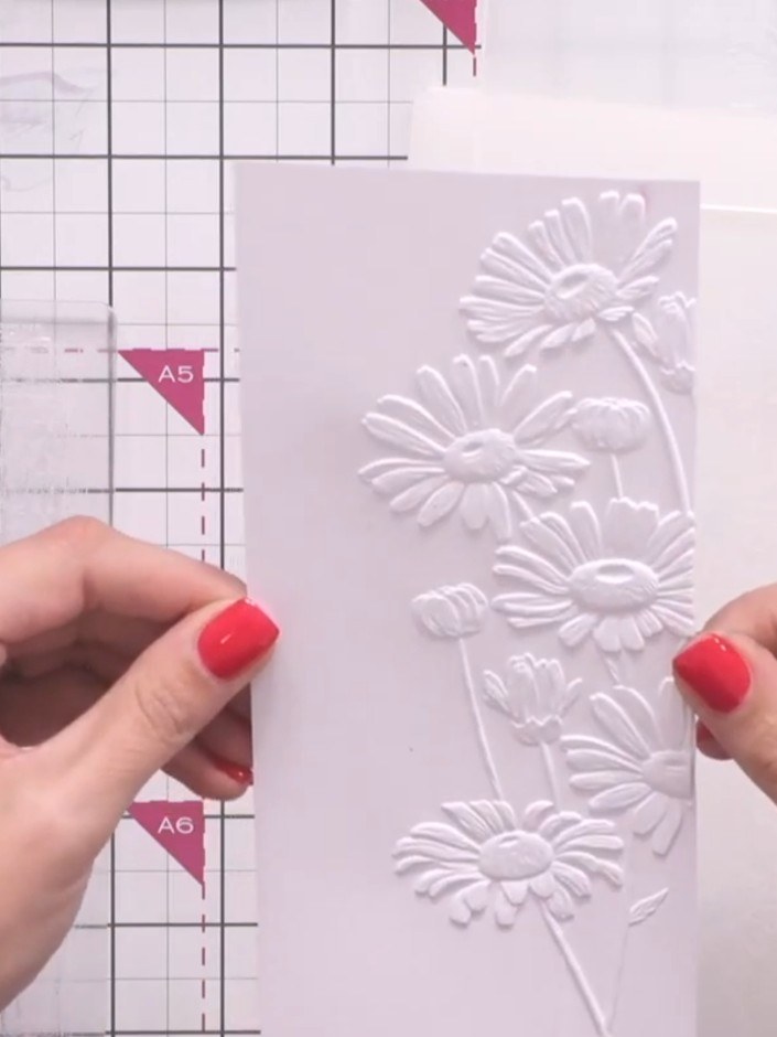 Step 5: Remove the embossed cardstock from the die-cutting machine. The white cardstock will now show the raised 3D da