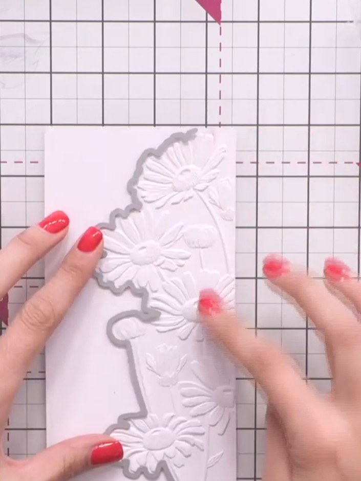 Step 6: Position the coordinating die around the embossed daisy design on your card to outline the section you wish to