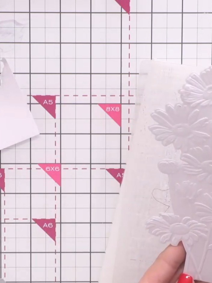 Step 8: Carefully remove the die-cut embossed daisy topper from the white cardstock, leaving the bottom edge attached 
