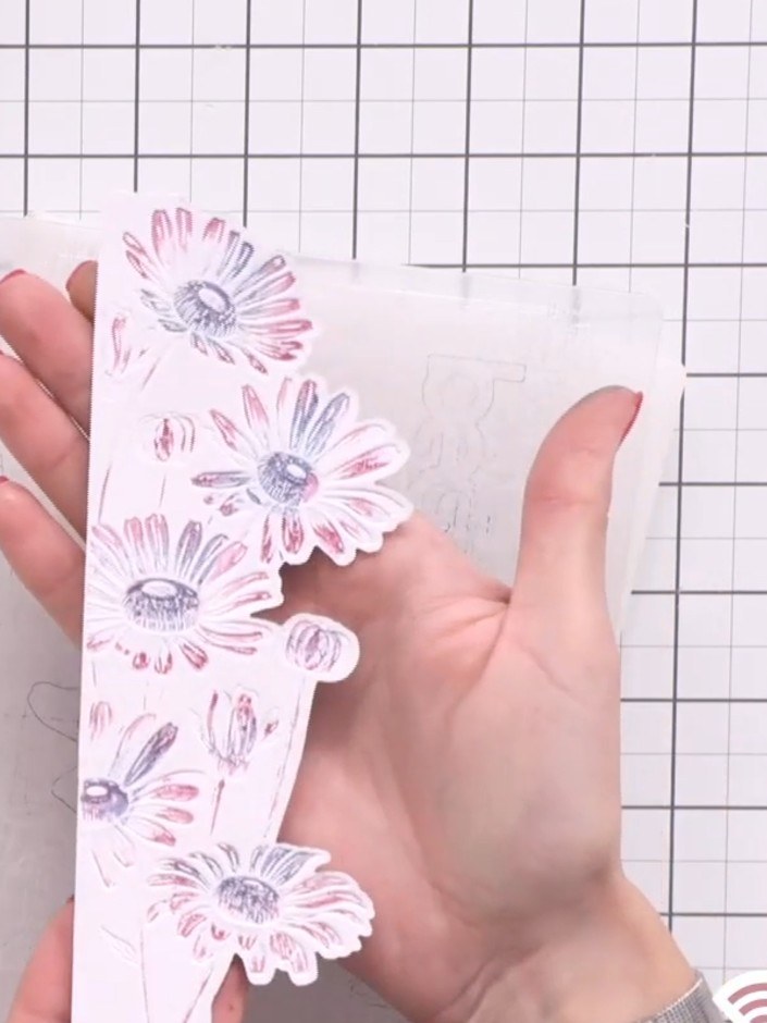 Step 9: Adhere foam pads to the back of the die-cut daisy topper to create dimension.