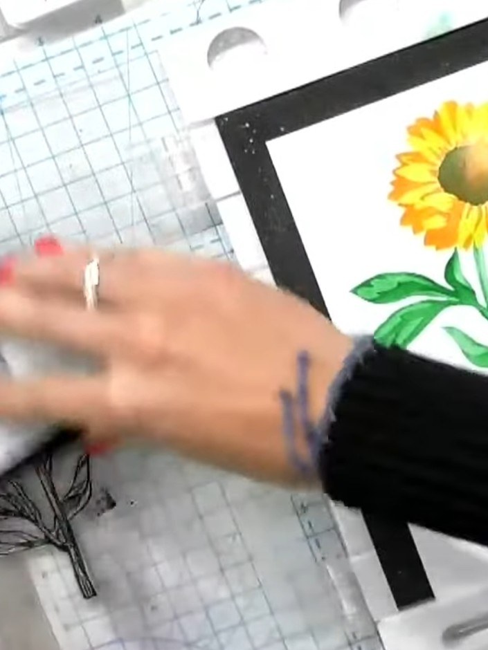 Passo 6: Stamp the flower stem from the Sunflower Quattro D stamp set in black ink over the stencilled design on your c